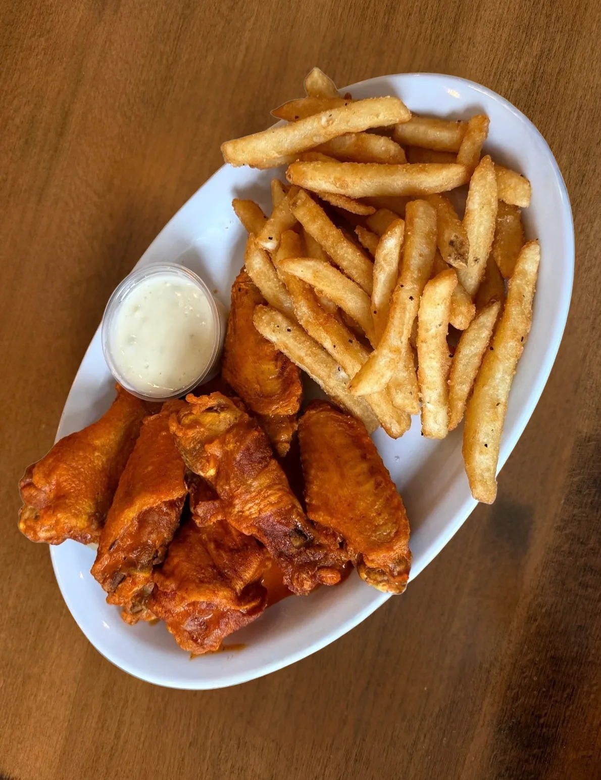 Buffalo wings with fries and ranch.