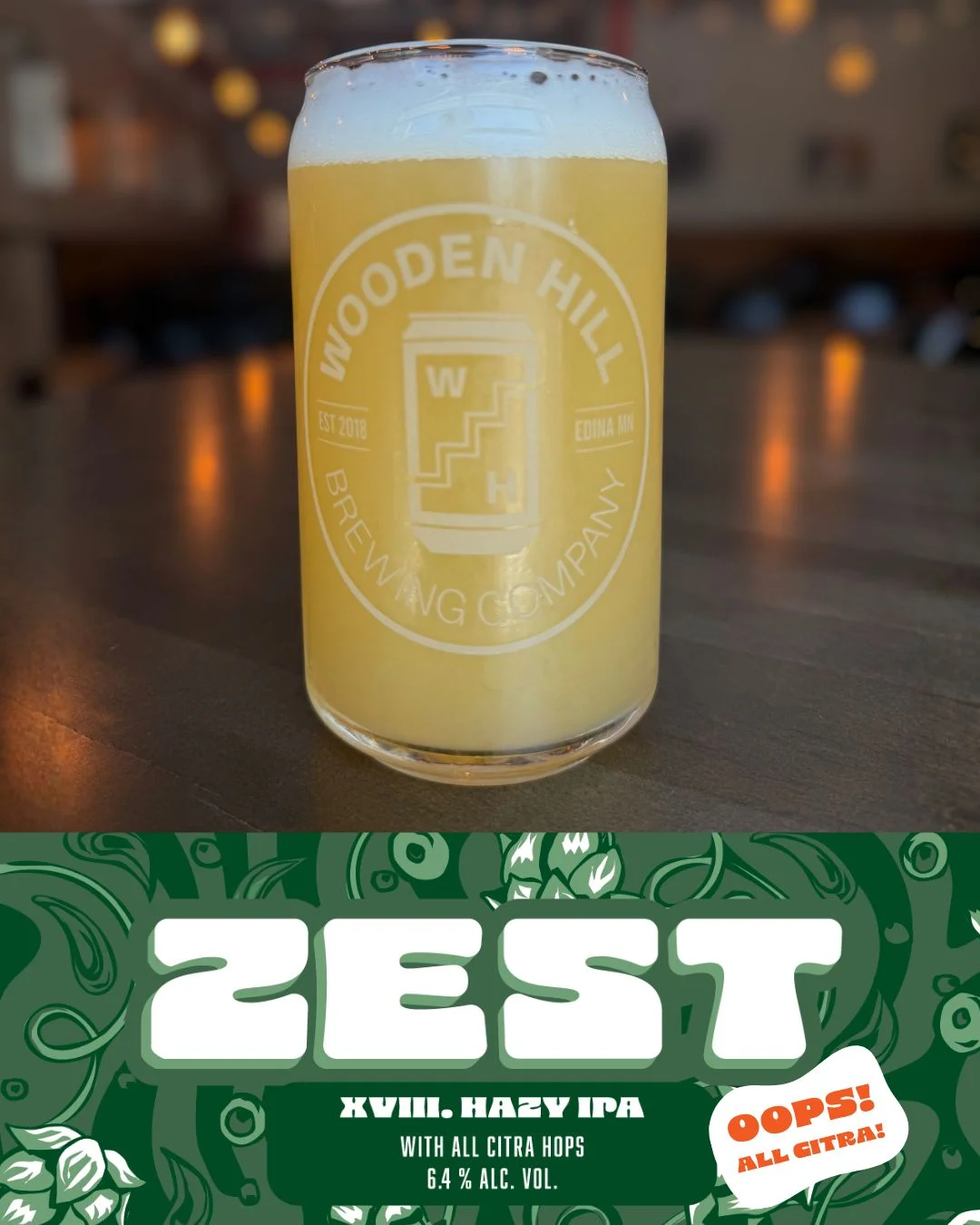 A glass of Zest with the Zest Oops all Citra logo XVIII. Hazy IPA with all citra hops 6.4% alc. vol.