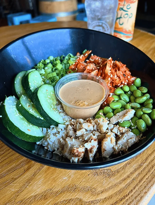 a Seoul bowl with a side of house soy harissa sauce