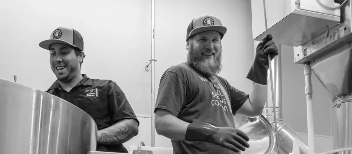 B&W photograph of James Ewen and Montana Davis during a brew day.
