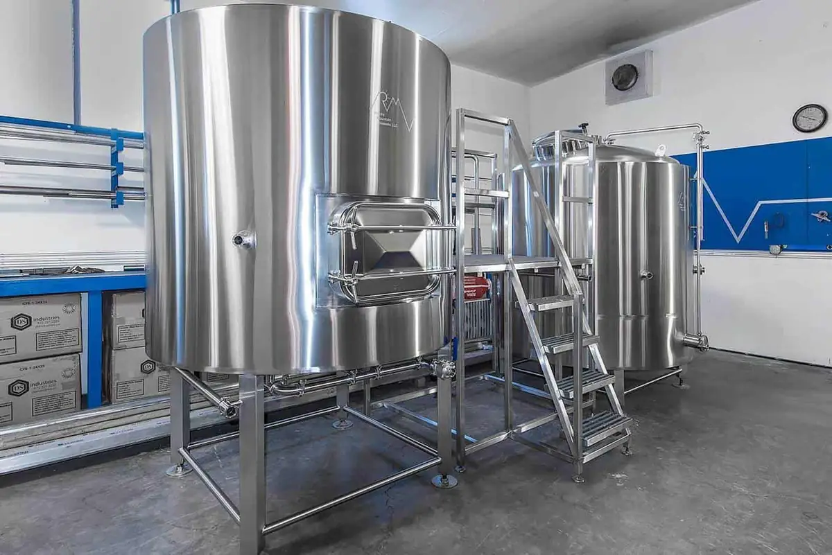 Example of a brewhouse comprised of a Mash/Lauter tun, platform, and brew kettle.