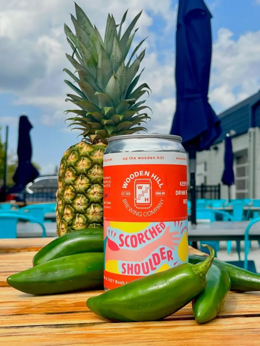 Photo of a crowler of "Scorched Shoulder" with jalapenos and pineapple in the photo