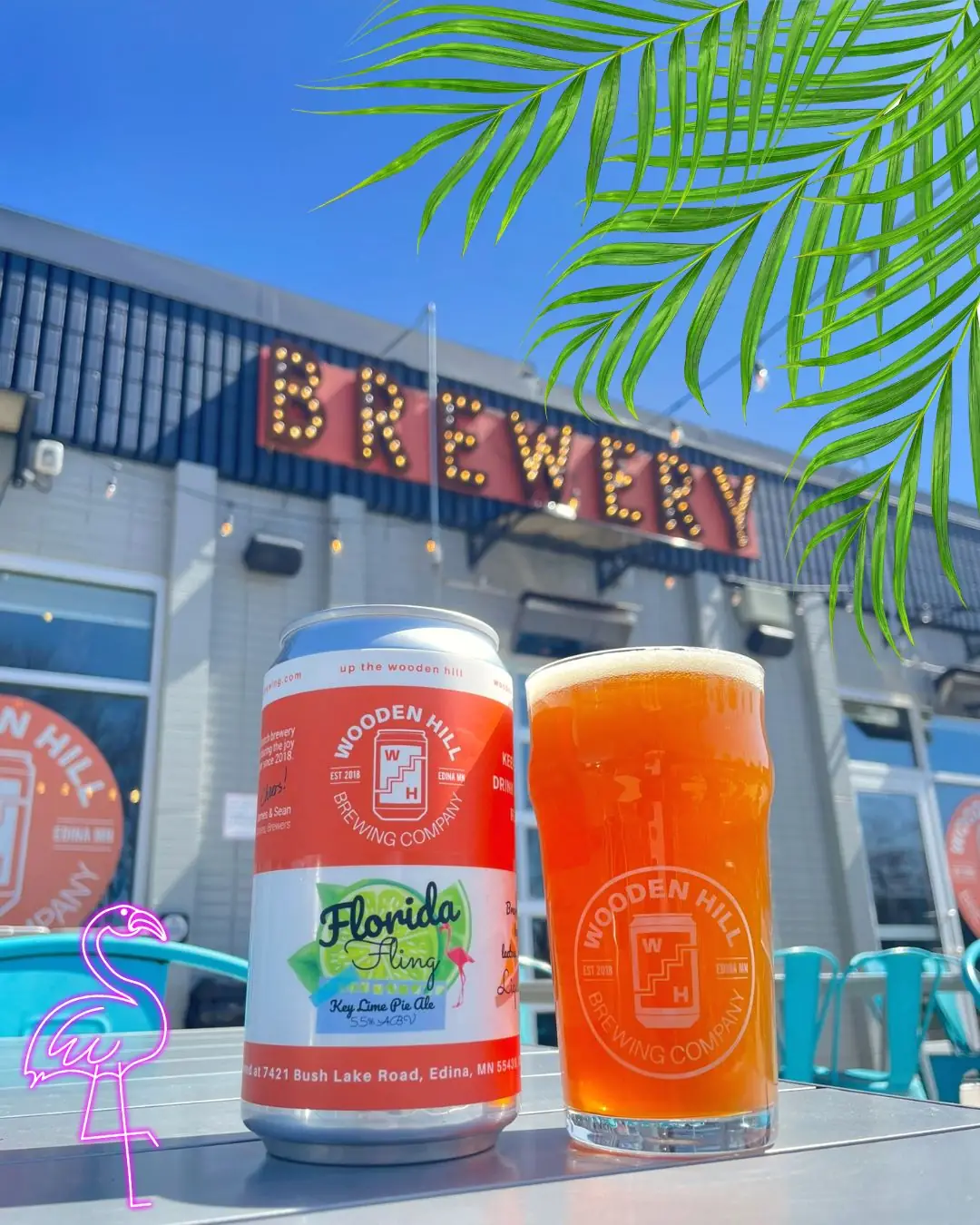 Picture of Florida Fling beer can and glass of beer. Picture is taken on our patio with the "Brewery" sign in the back with added palm tree and flamingo graphics
