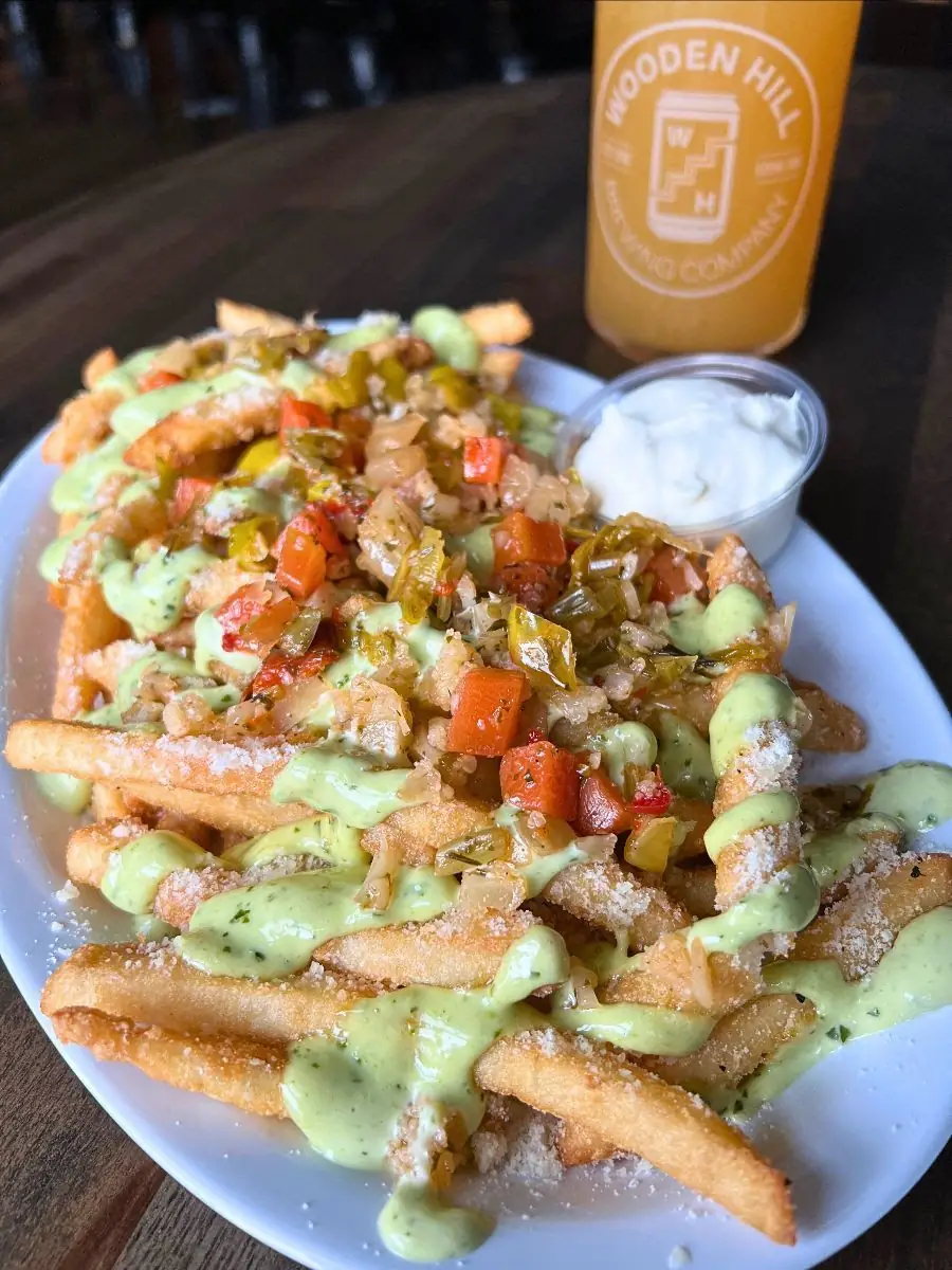 Soprano fries on a plate with a beer in the background.