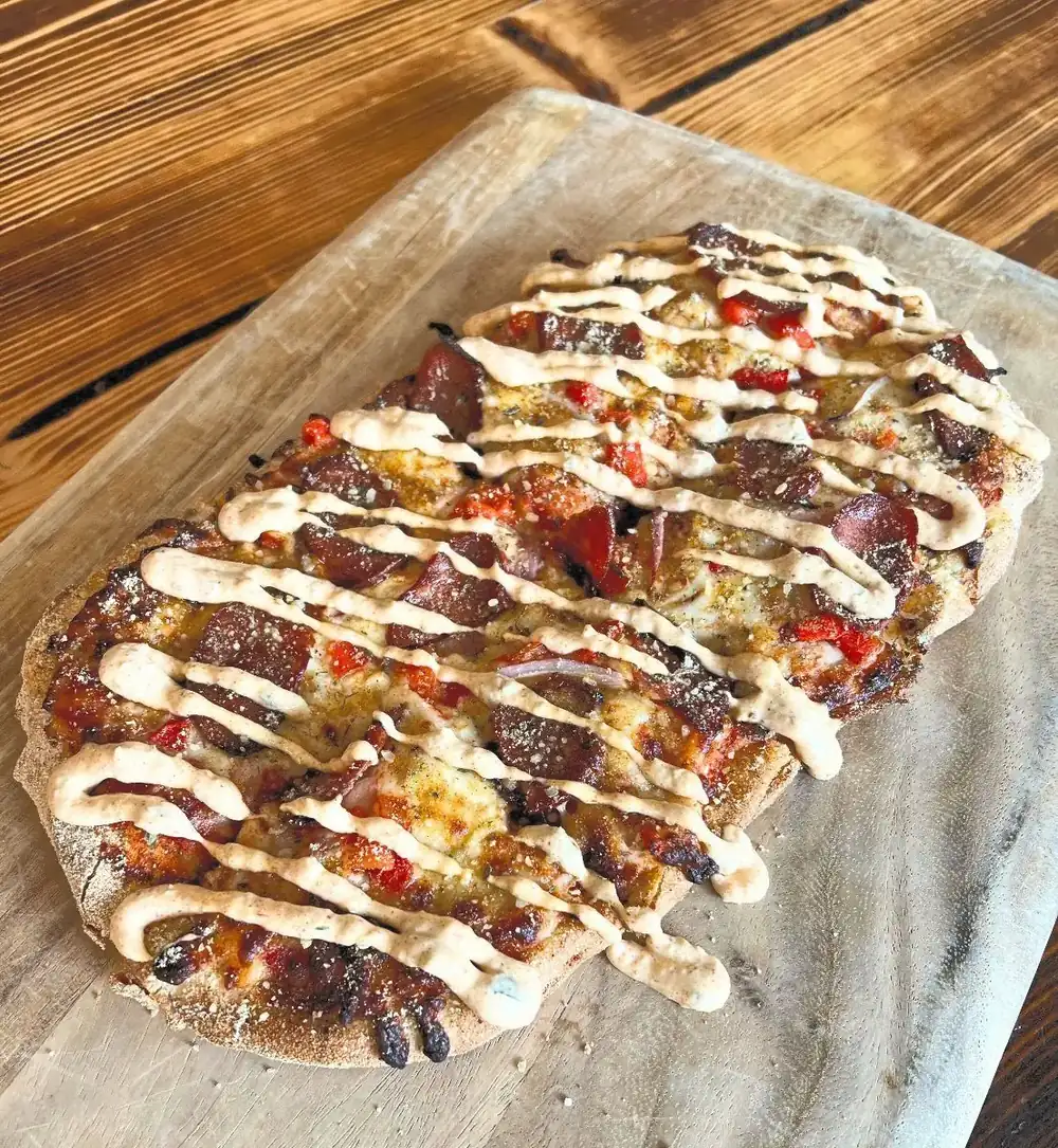 Our new Cajun Flatbread on a wood board. 