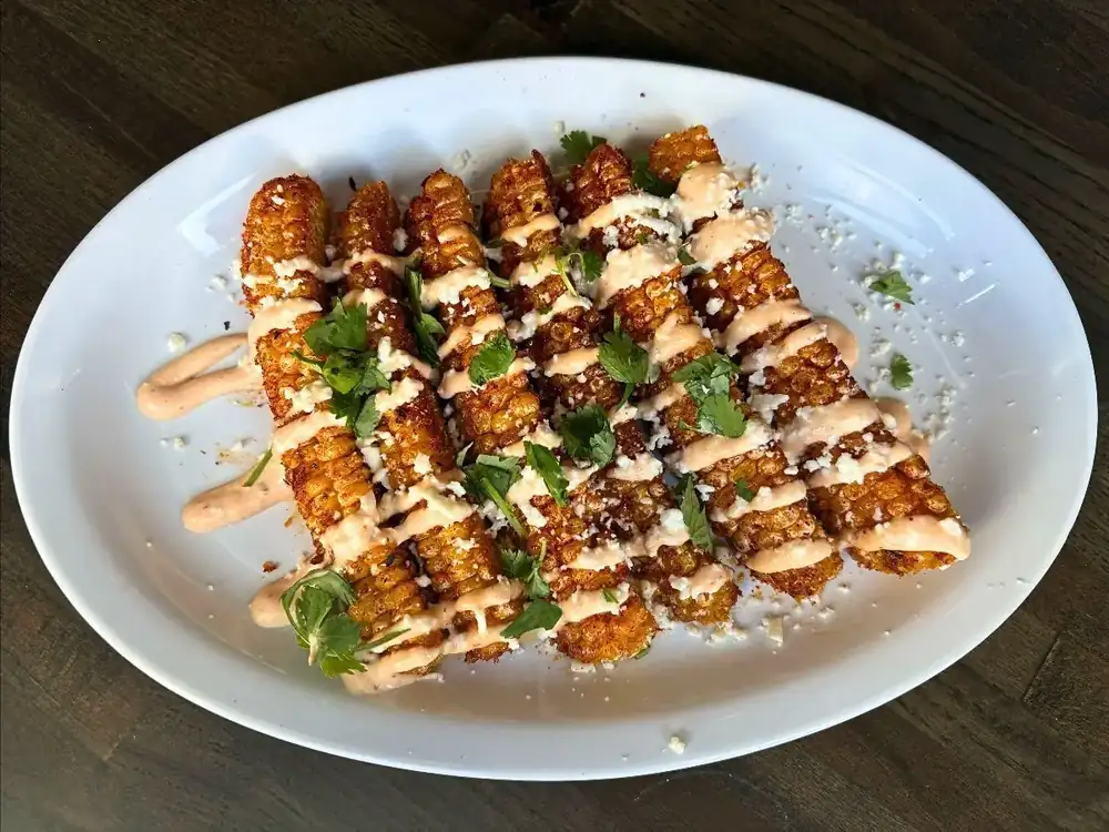 Image of street corn ribs on a plate.