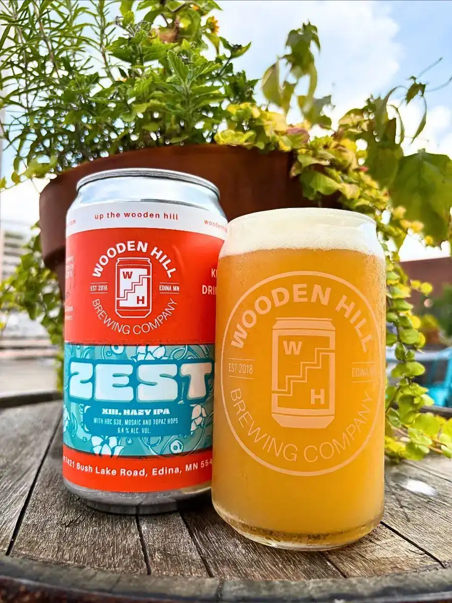 Our Zest series continues with Zest XIII. Picture shows a can and glass of Zest XIII, with a plant in the background.