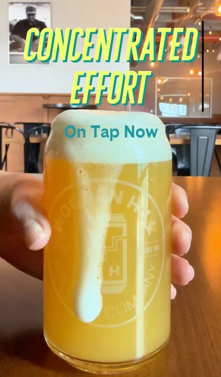 Picture of someone holding a glass of Concentrated Effort with text on the picture saying "concentrated effort - On Tap Now"