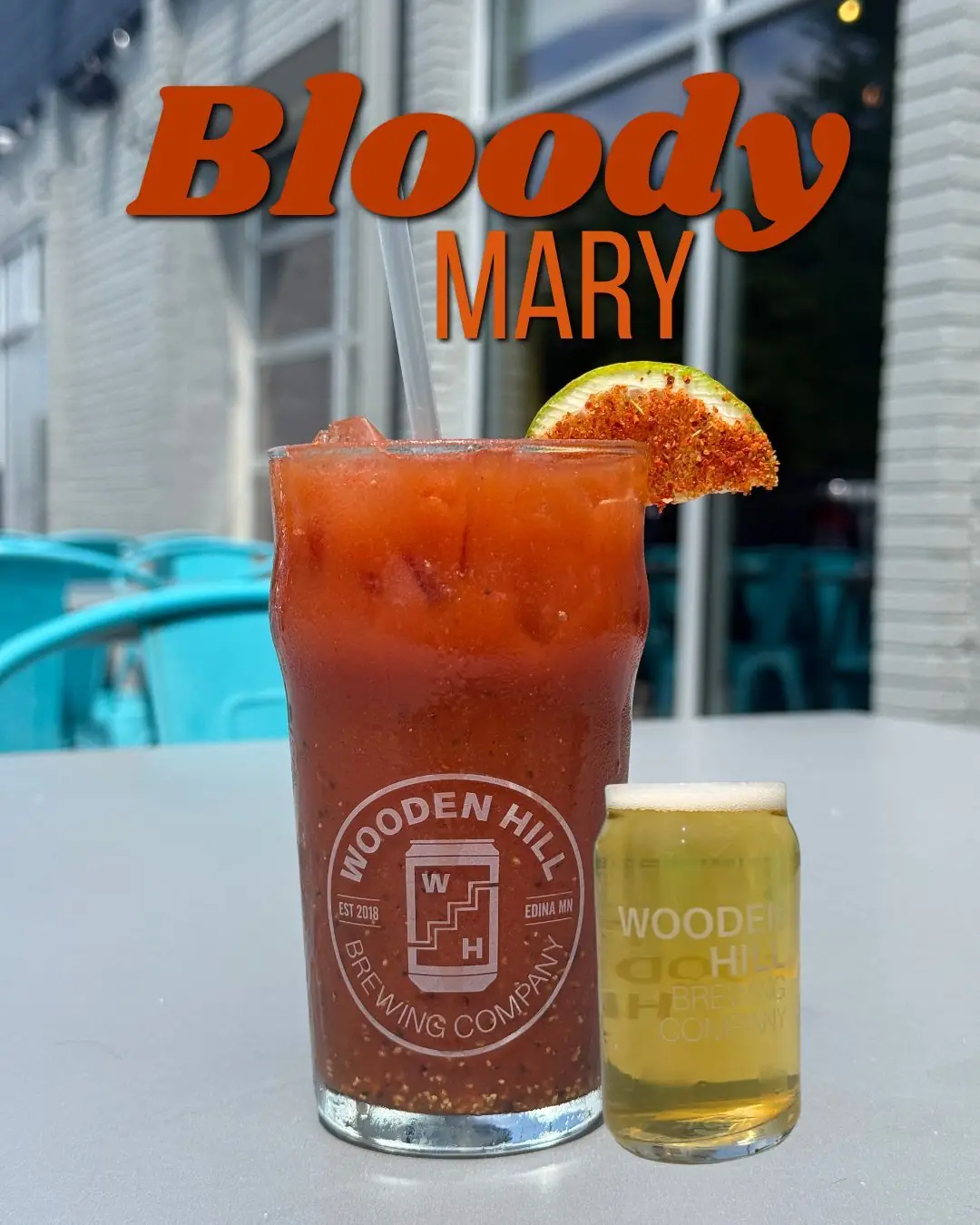 A glass of Bloody Mary Cocktail  garnished with a celery salt dipped lime wedge and a side beer chaser with text overlay "Bloody Mary"