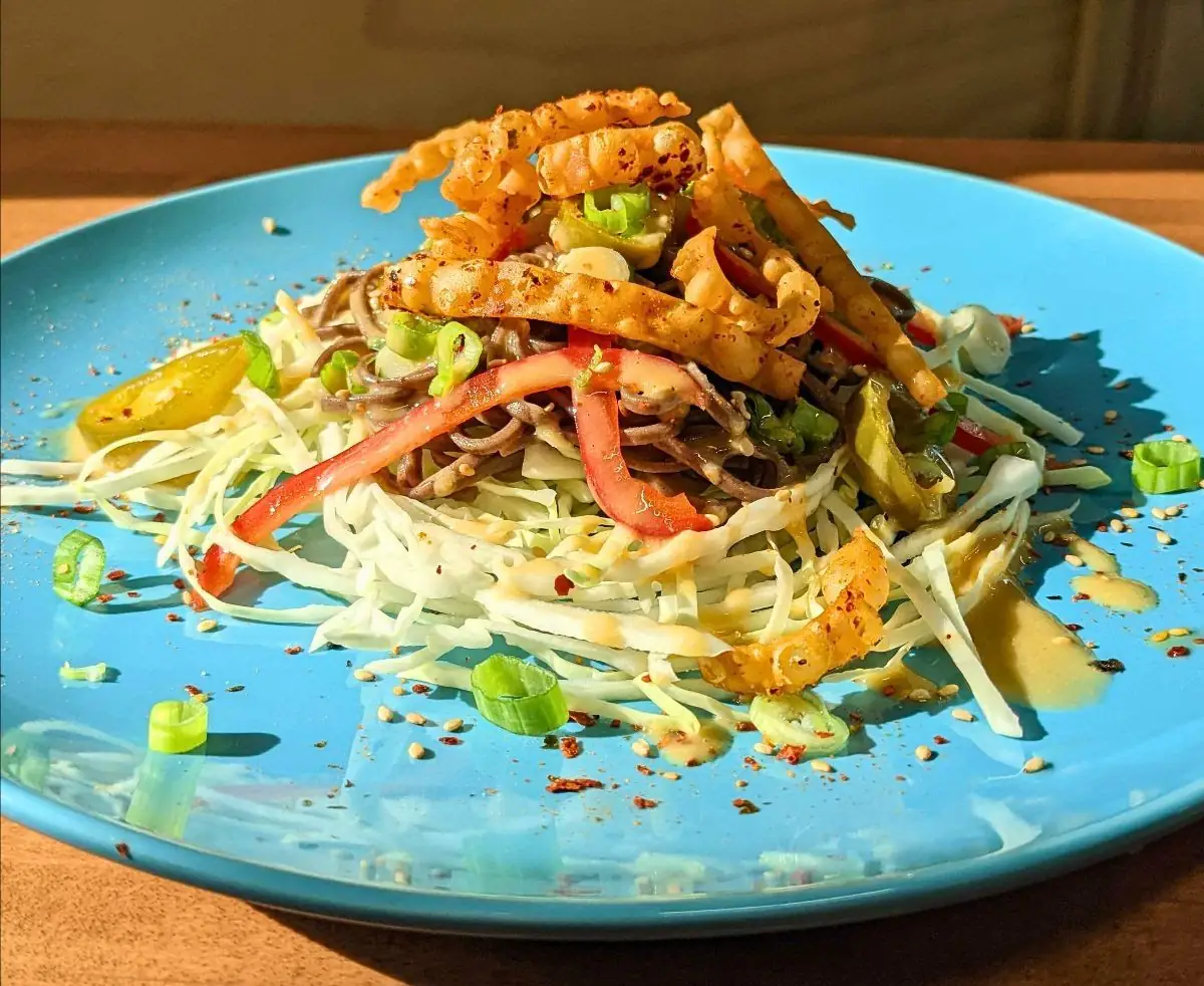 Image of soba salad on a blue plate.