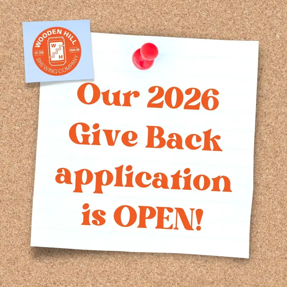 Graphic for 2026 give back application. Note on a bulletin board that says our 2026 give back application is open with a Wooden Hill logo.